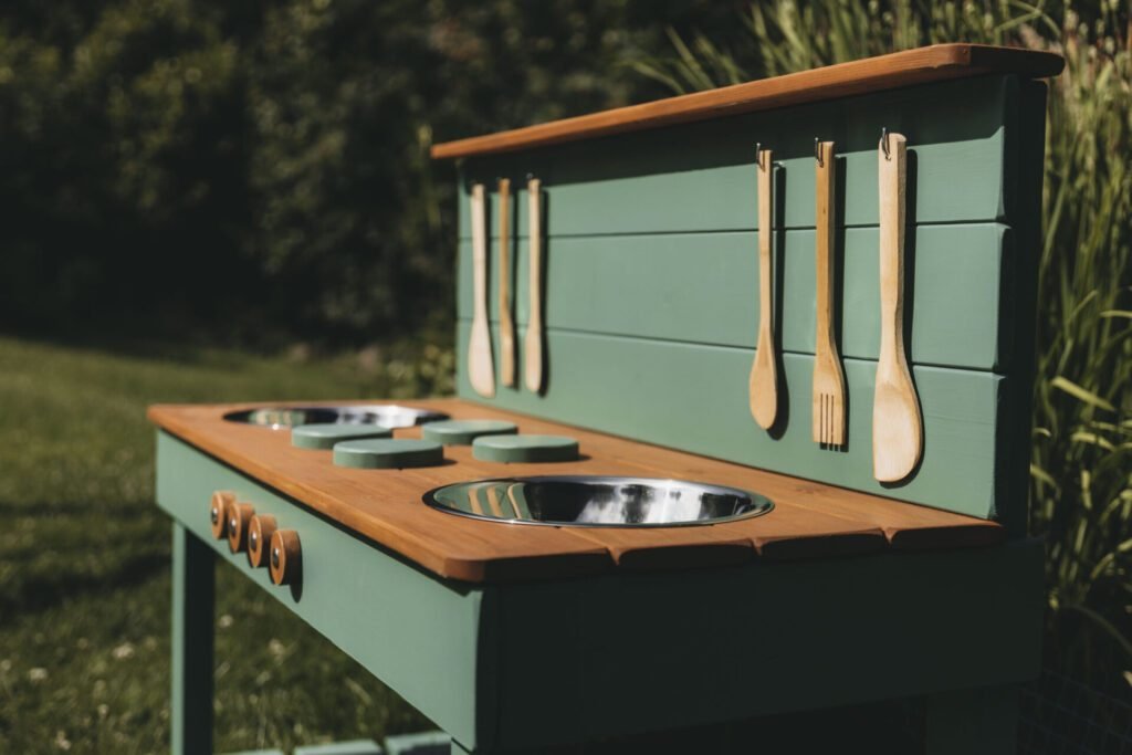 Detail of a sage green mud kitchen worktop