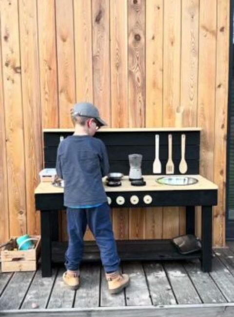 A mud kitchen set up and enjoyed outdoors