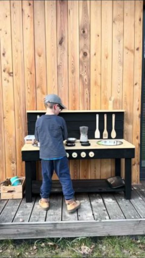 Kids enjoying screen-free outdoor play at their mud kitchen