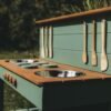 Hand-painted burners and wooden knobs on a mud kitchen worktop