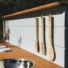 Wooden mud kitchen standing outdoors in wet weather