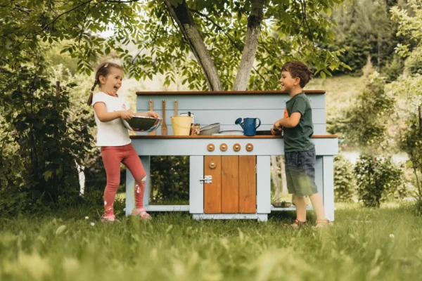 Handcrafted solid spruce wooden mud kitchen in a UK garden