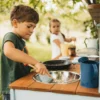 Handcrafted solid spruce wooden mud kitchen in a UK garden