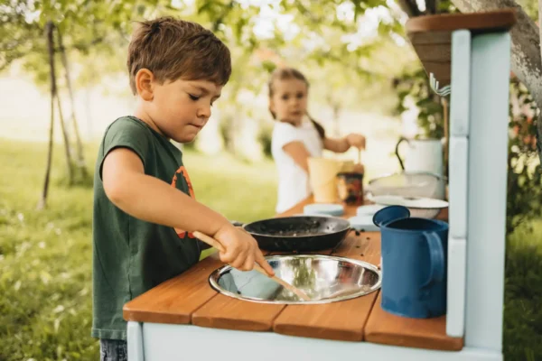 Handcrafted solid spruce wooden mud kitchen in a UK garden