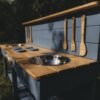 Kuchnie-Blotne_7-scaled-1920x1280-1 Close-up of solid spruce timber on a handcrafted mud kitchen